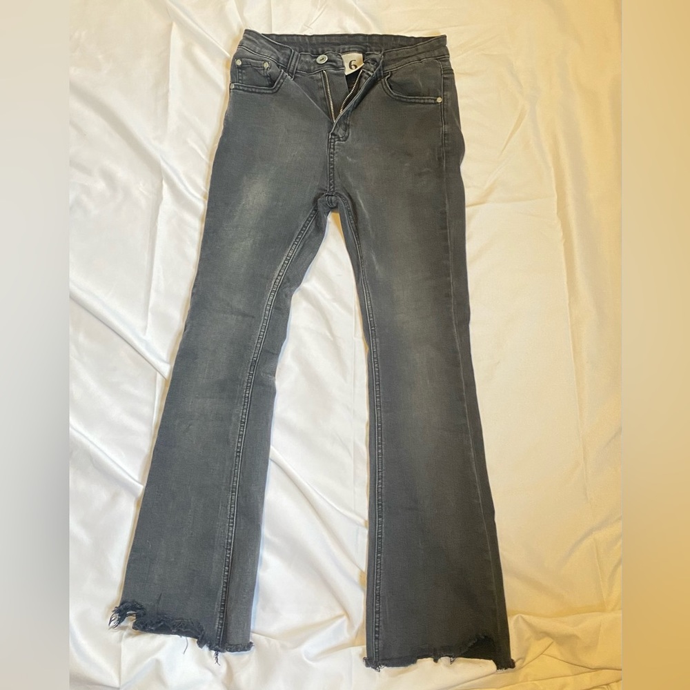black washed tight fitting wide legged at the bottom jeans